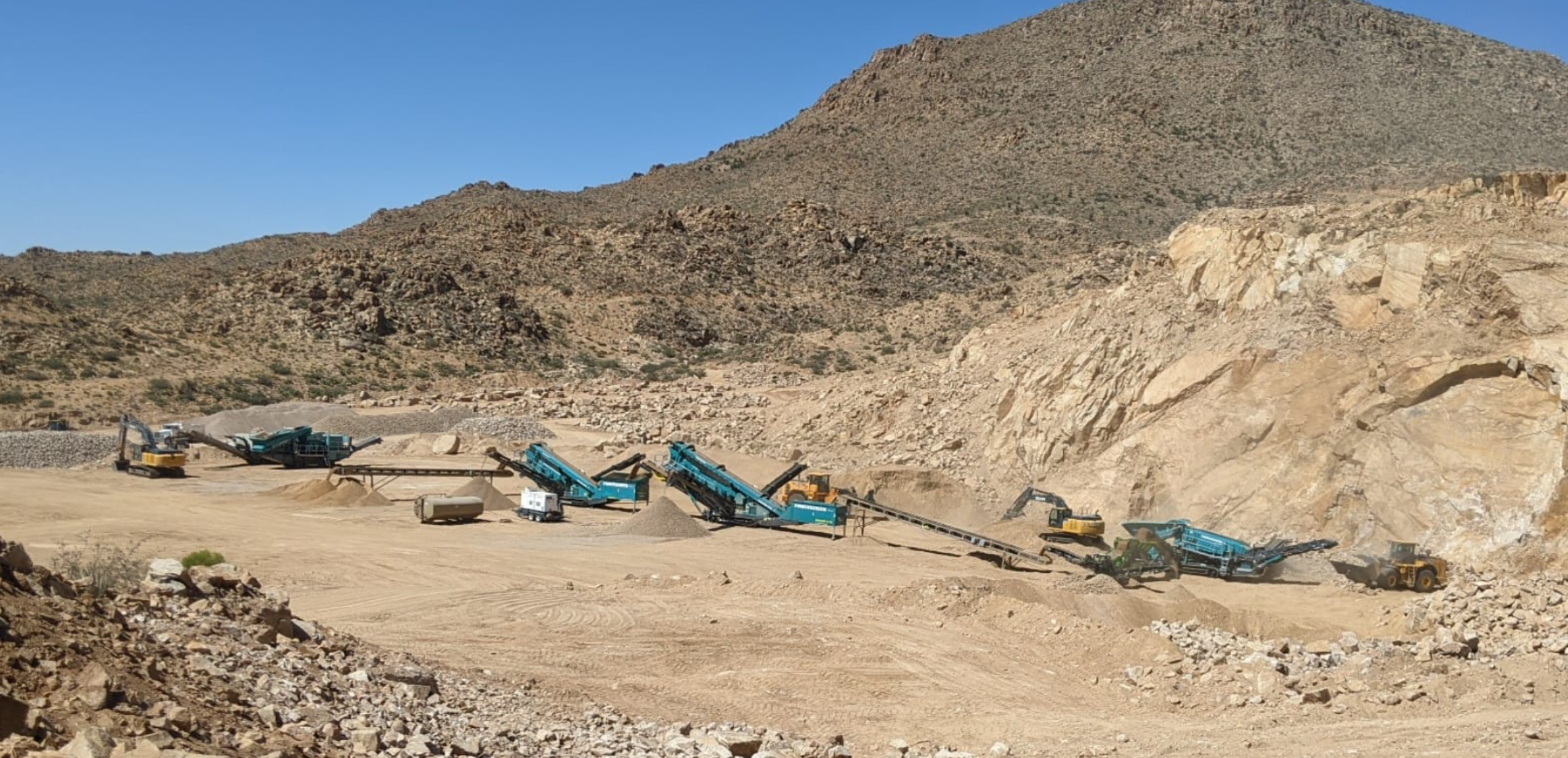 Onyx Crushing plant operating in an Arizona quarry with the mountain ridge behind